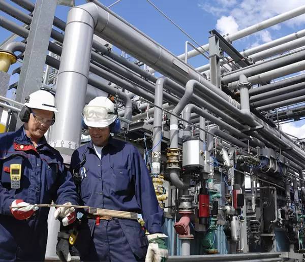 engineers outside refinery