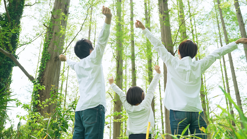 Asian family relaxing in the forest