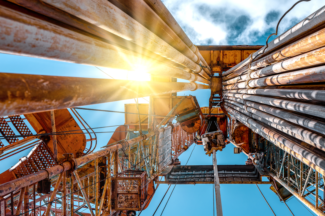 Oil and Gas Drilling Rig onshore dessert with dramatic cloudscape