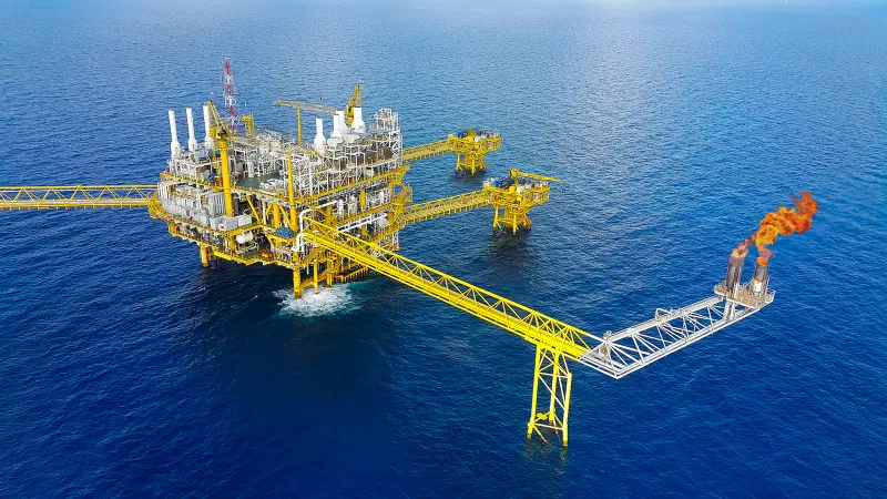 Oil rig in ocean with flare