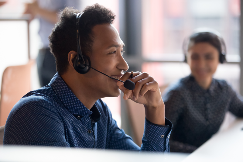 Smiling young african businessman call center agent