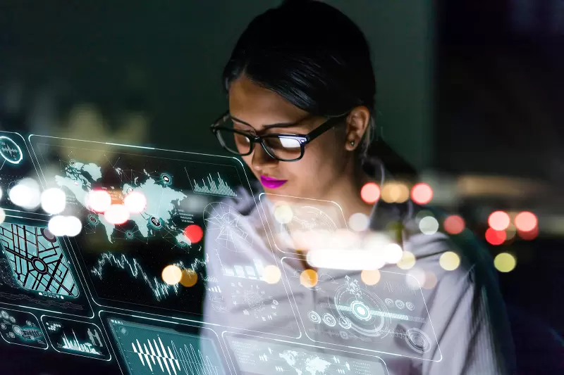 businesswoman looking at futuristic interface screen